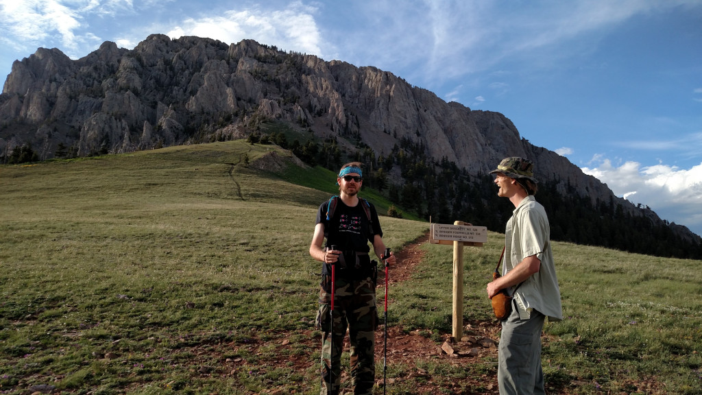 The top of the pass. Apparently something was just hilarious. Ross Peak in the background. The right side looks like the most viable route to the top.