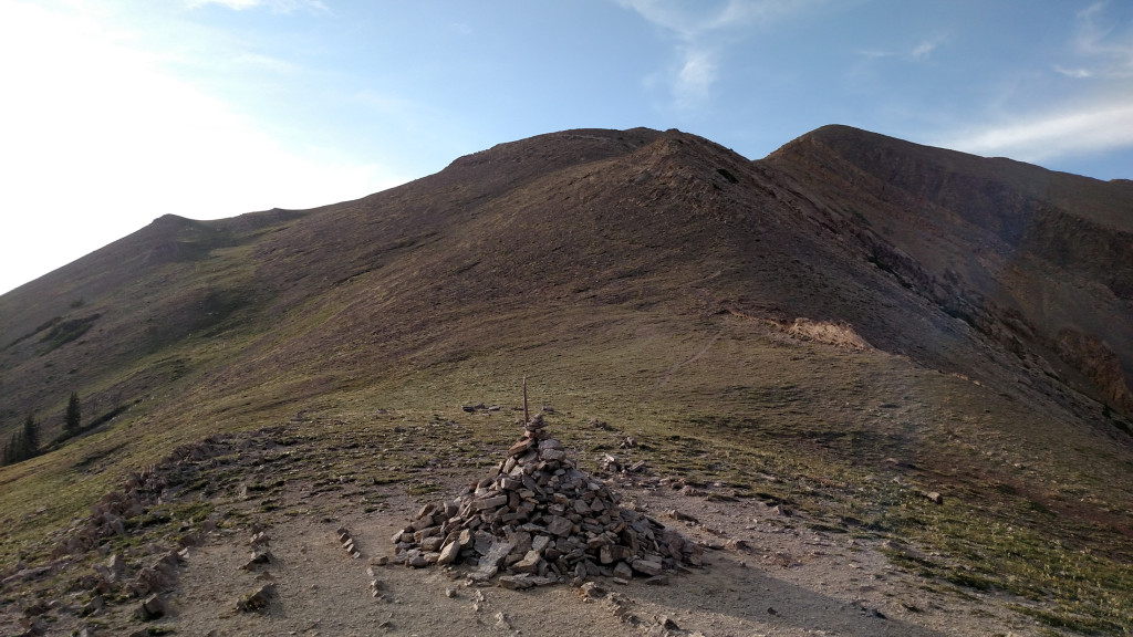 A trail leads north to Pomp Peak and Hardscrabble.