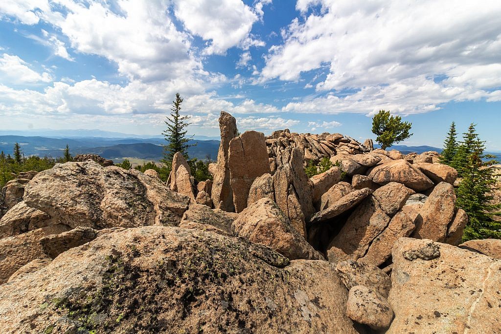 The summit of Haystack Mountain is mostly just heaping pile of granite boulders. The true summit is either the narrow boulder sticking up in the center left or the wider boulder behind it to the right. A fire lookout use to exist on the summit but little evidence of it remains.