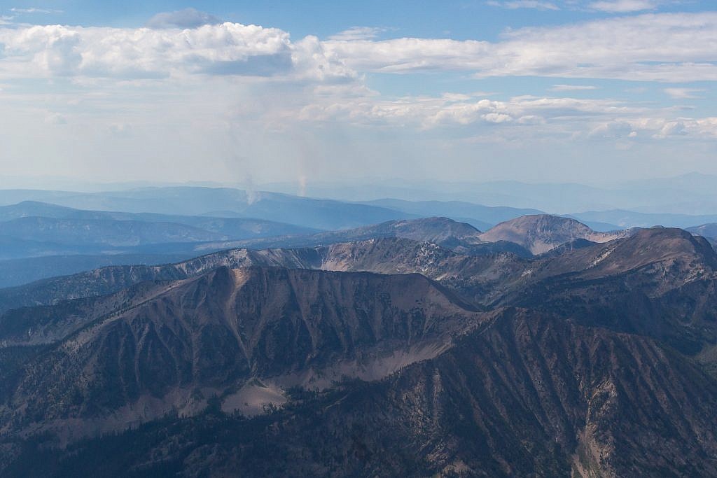 Closeup shot of what appears to be some small forest fires burning in the distance.